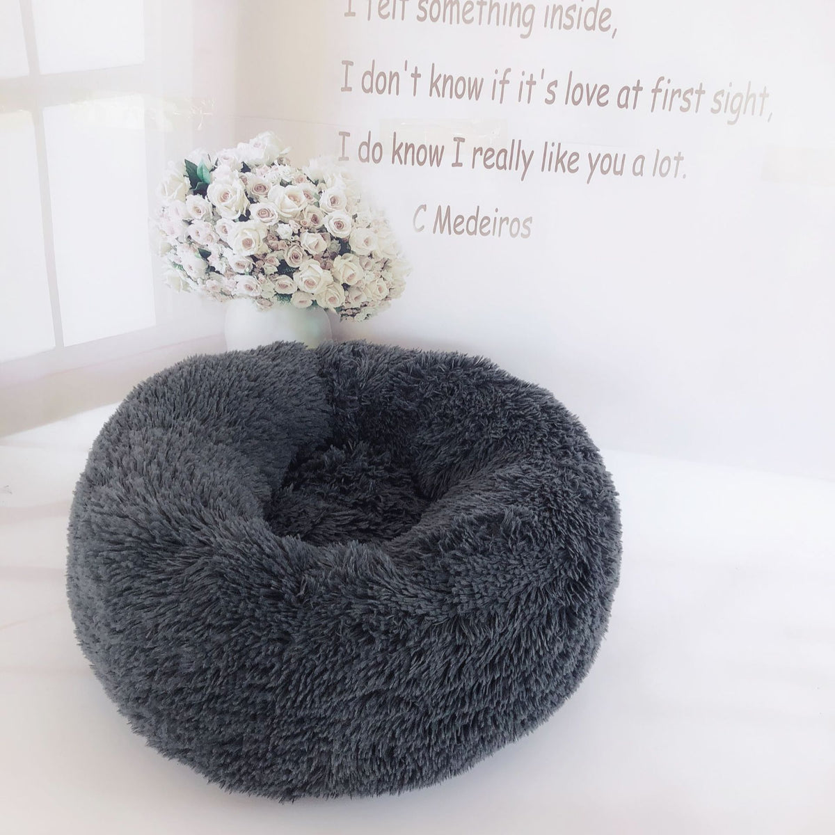 Soft plush pet nest bed by CareHaven, cozy round resting spot for dogs and cats with cushioned edges and plush interior.