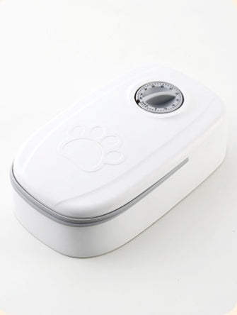 CareHaven automatic pet feeder and water dispenser for dogs and cats, with food and water bowls on a kitchen countertop.